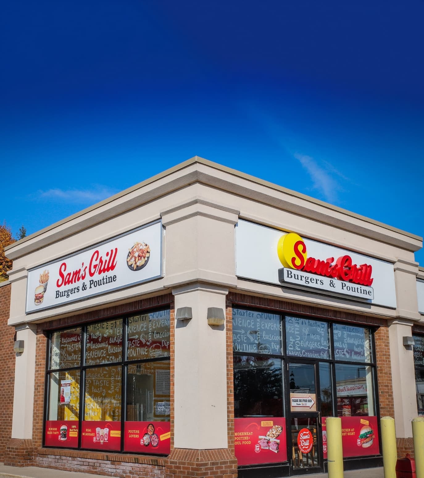The Sam's Grill storefront under a blue sky